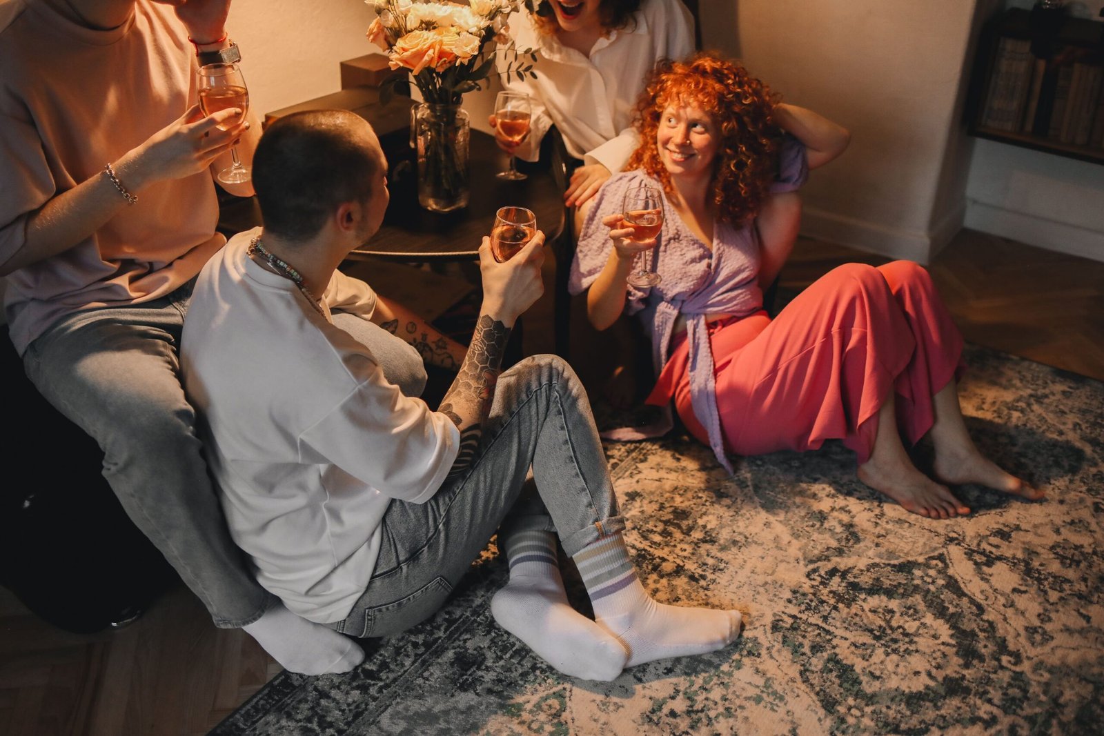 People sit together and talk at a small indoor gathering.