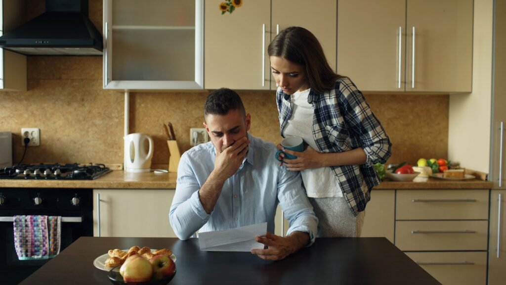 Couple looking at a document together at their kitchen table